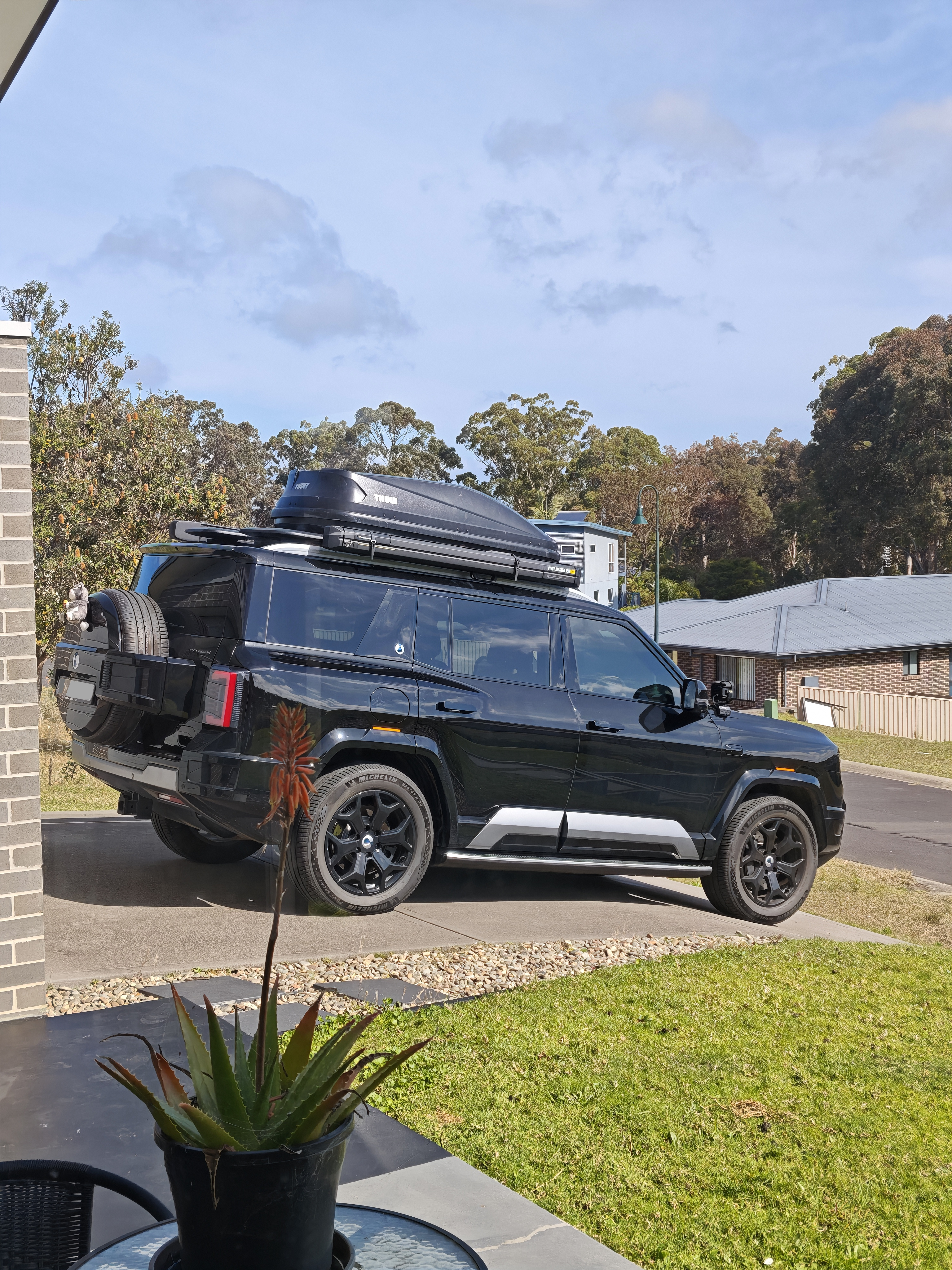 Mo’s Denza B8 in Eden, with roof equipment and plushie; number plate covered